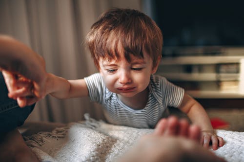 Free Close-Up Photo of a Kid in a Striped Shirt Crying Stock Photo
