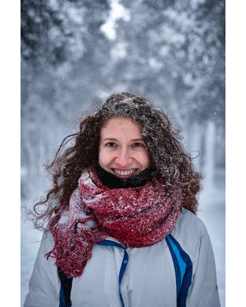 Portrait of a Woman with a Red Scarf Covered in Snow