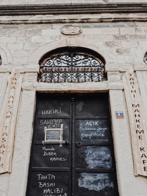 Free Vintage Turkish door with ornate metalwork and engraved stone arch. Perfect for cultural contexts. Stock Photo