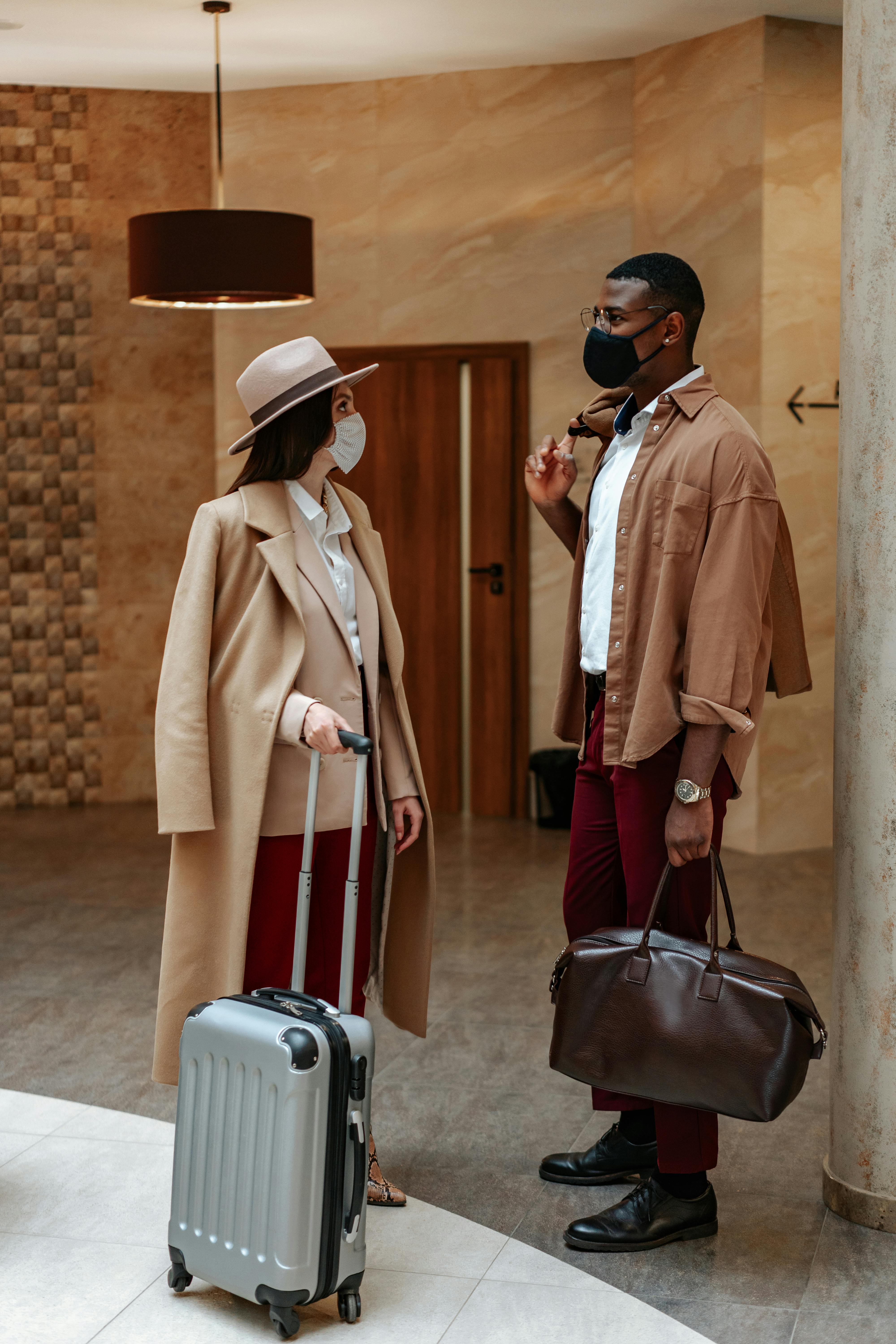 photo of a man with a brown bag talking to a woman beige coat