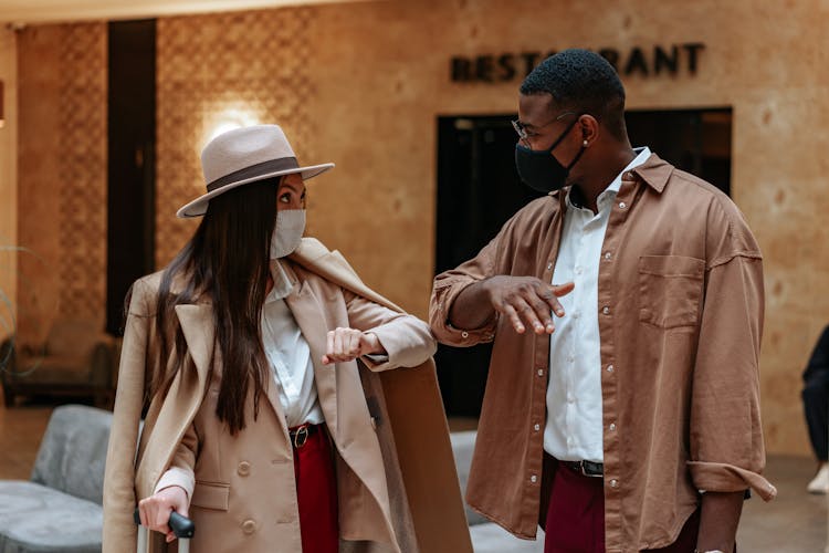 Man And Woman Doing Elbow Bump To Greet Each Other