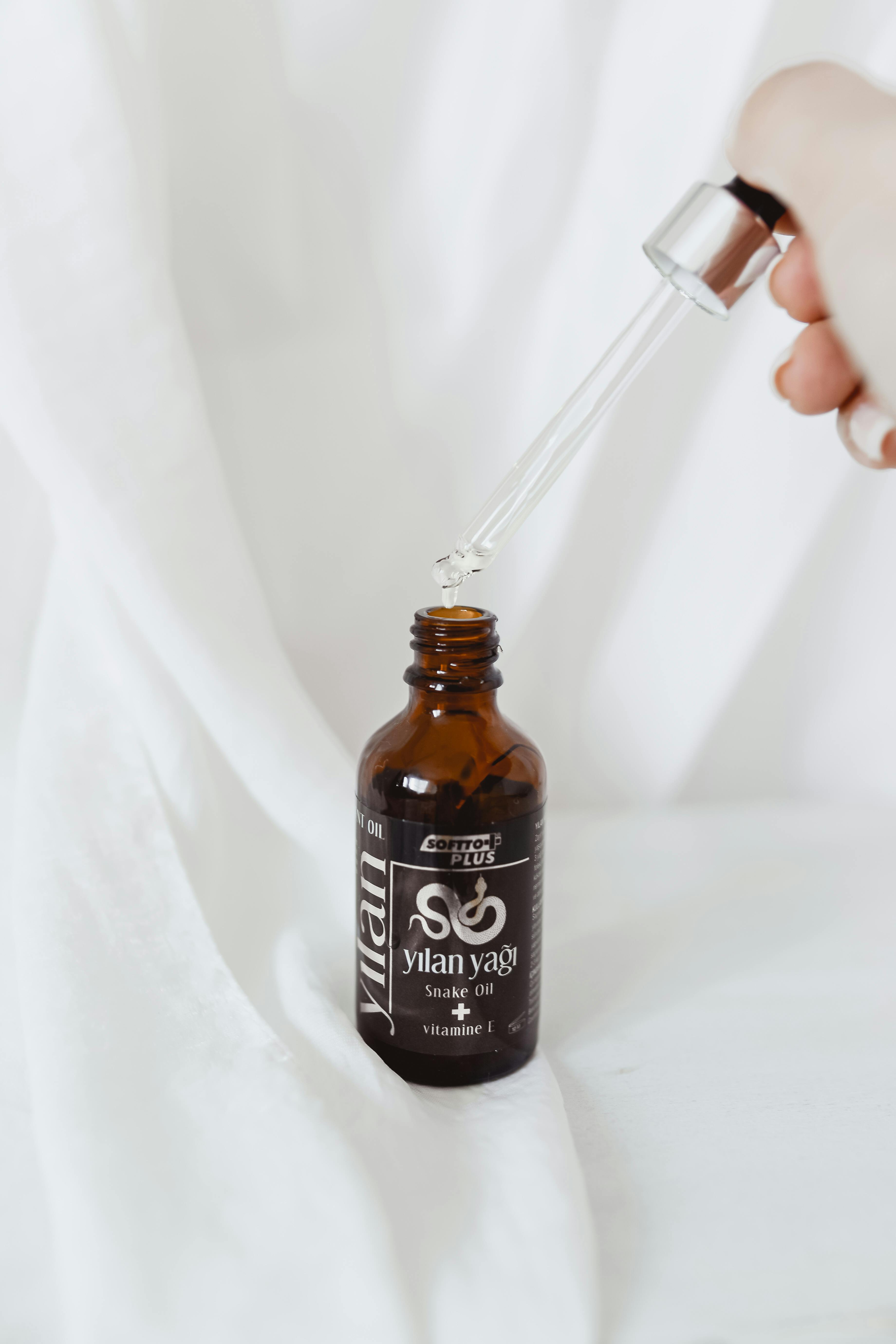 Person Holding a Dropper · Free Stock Photo