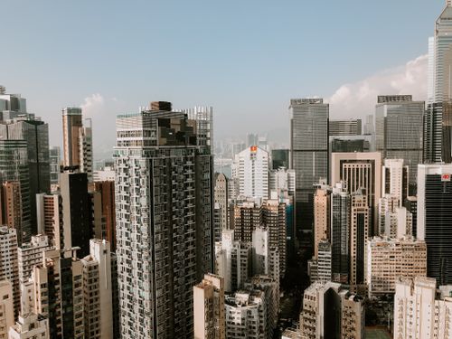 Free From above of contemporary multistory buildings located in central district of city under blue sky in daylight Stock Photo