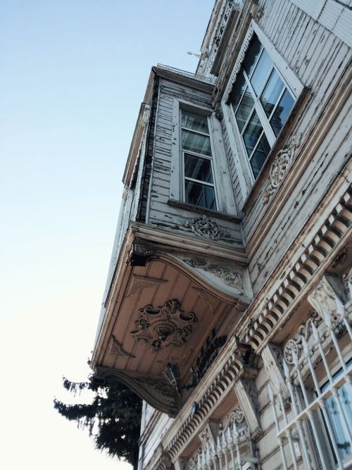 Free Low angle view of a historic ornate wooden facade with intricate carvings and large windows. Stock Photo