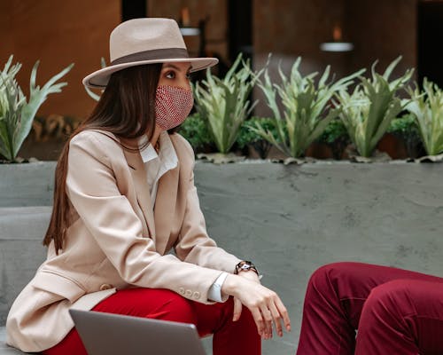 Woman in a Beige Blazer Wearing a Red Face Mask