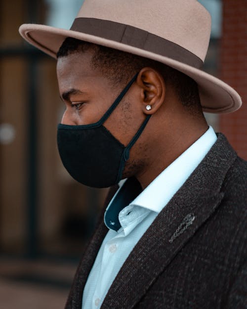 Close-Up Photo of a Man Wearing a Black Face Mask