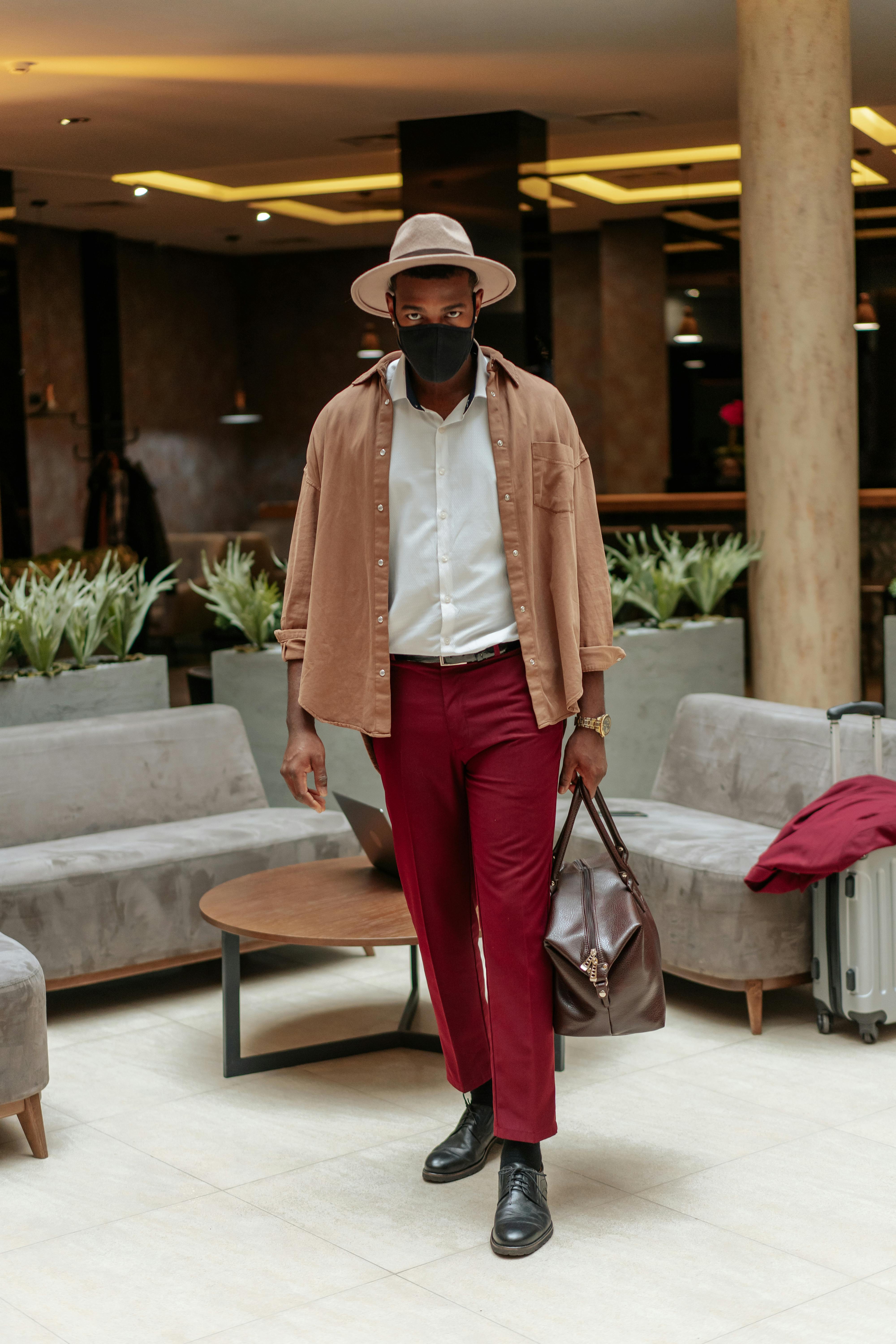 photograph of a man in red pants walking