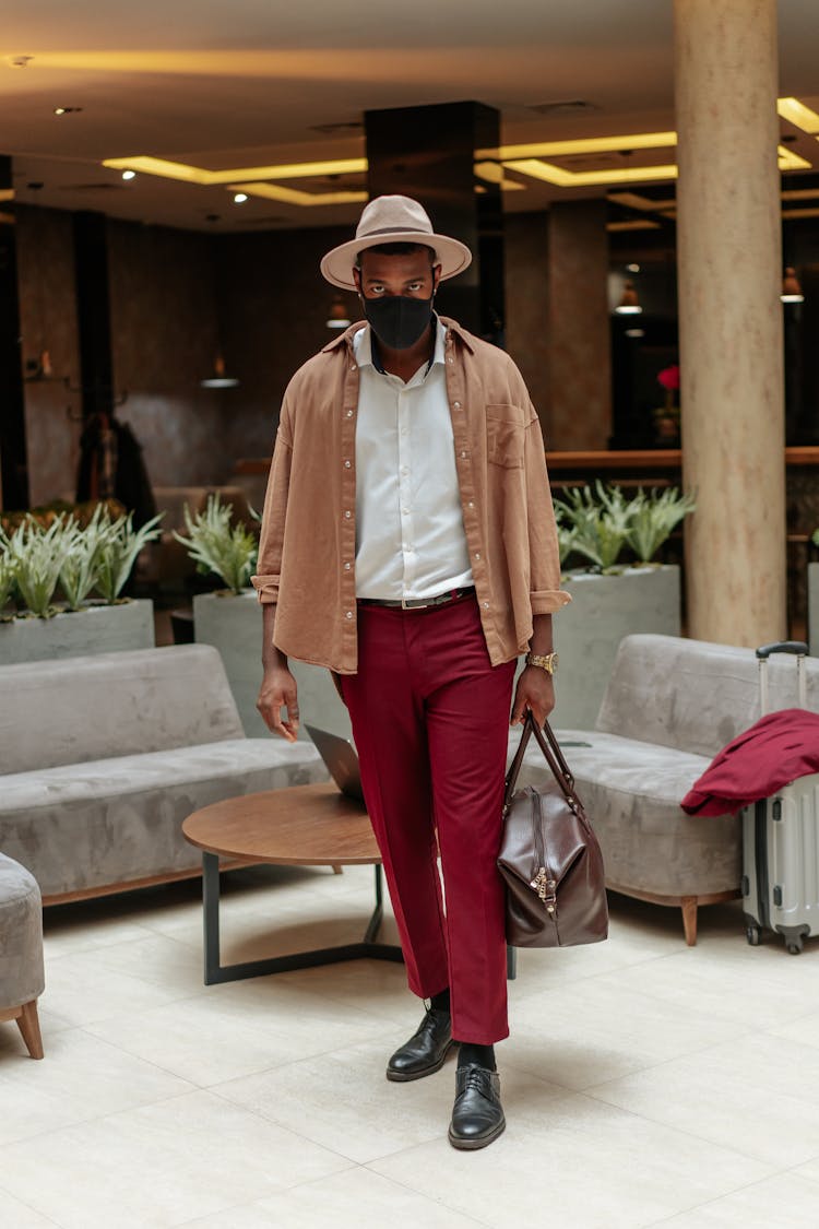 Photograph Of A Man In Red Pants Walking