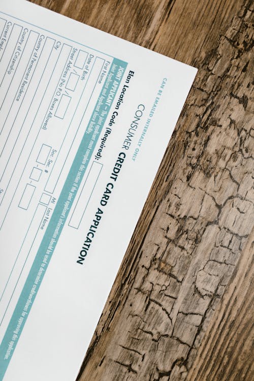 Free Credit Card Application Form on Wooden Surface  Stock Photo