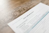 White Printer Paper on Brown Wooden Table