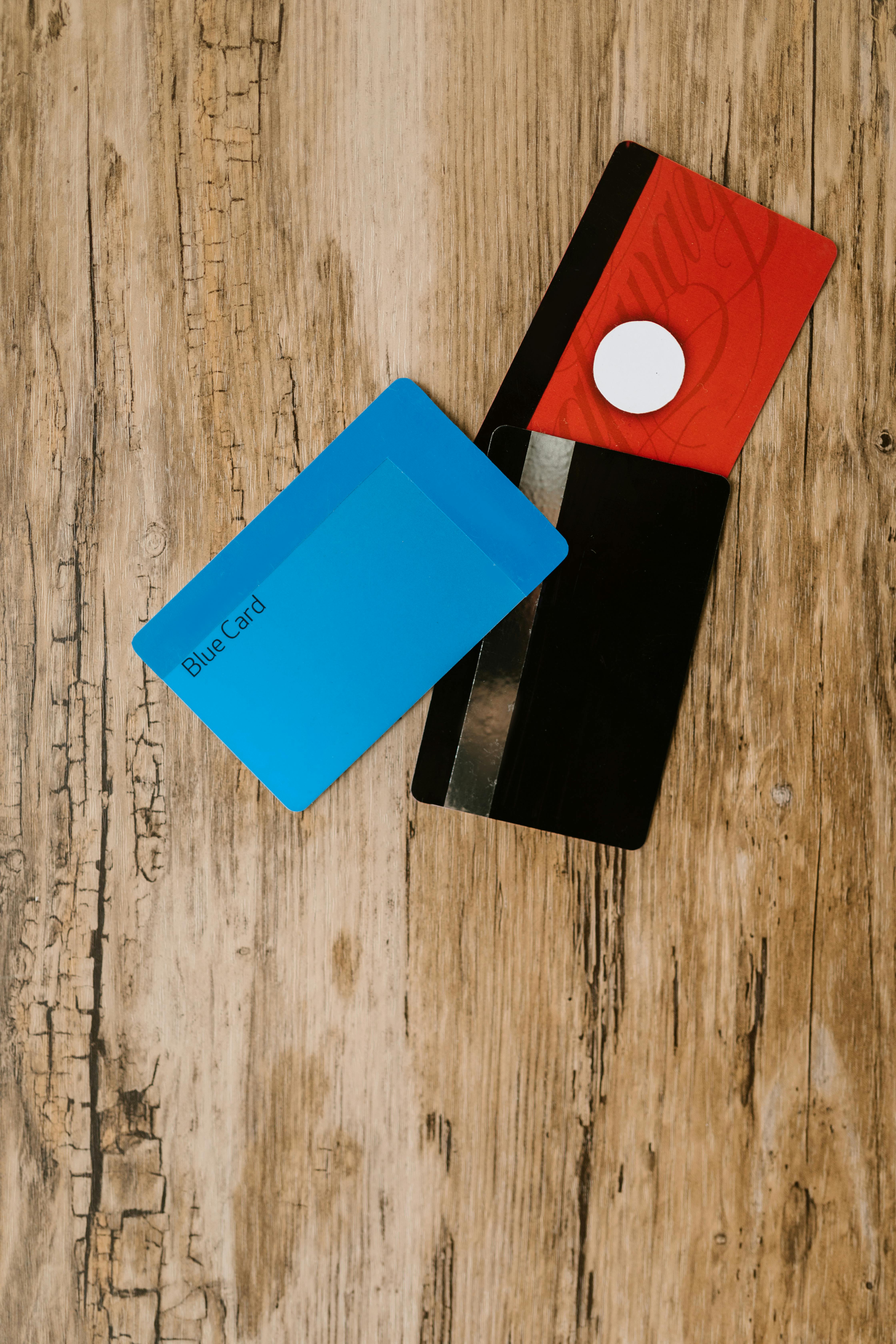 blue and black card on brown wooden table