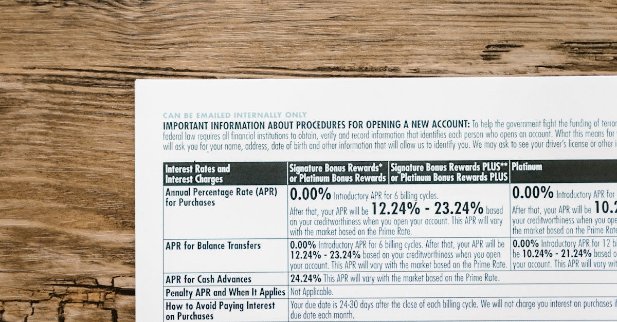 Photo by RDNE Stock project A detailed financial document listing interest rates on a textured wooden table.
