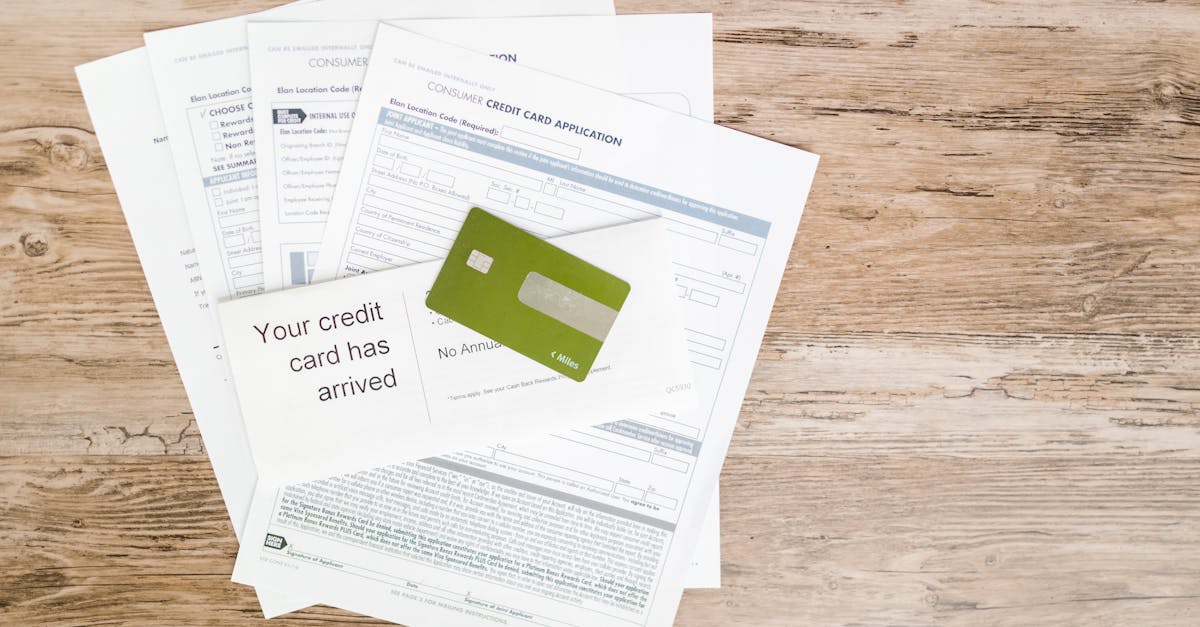 Photo by RDNE Stock project Top view of credit card and application documents on wooden surface.