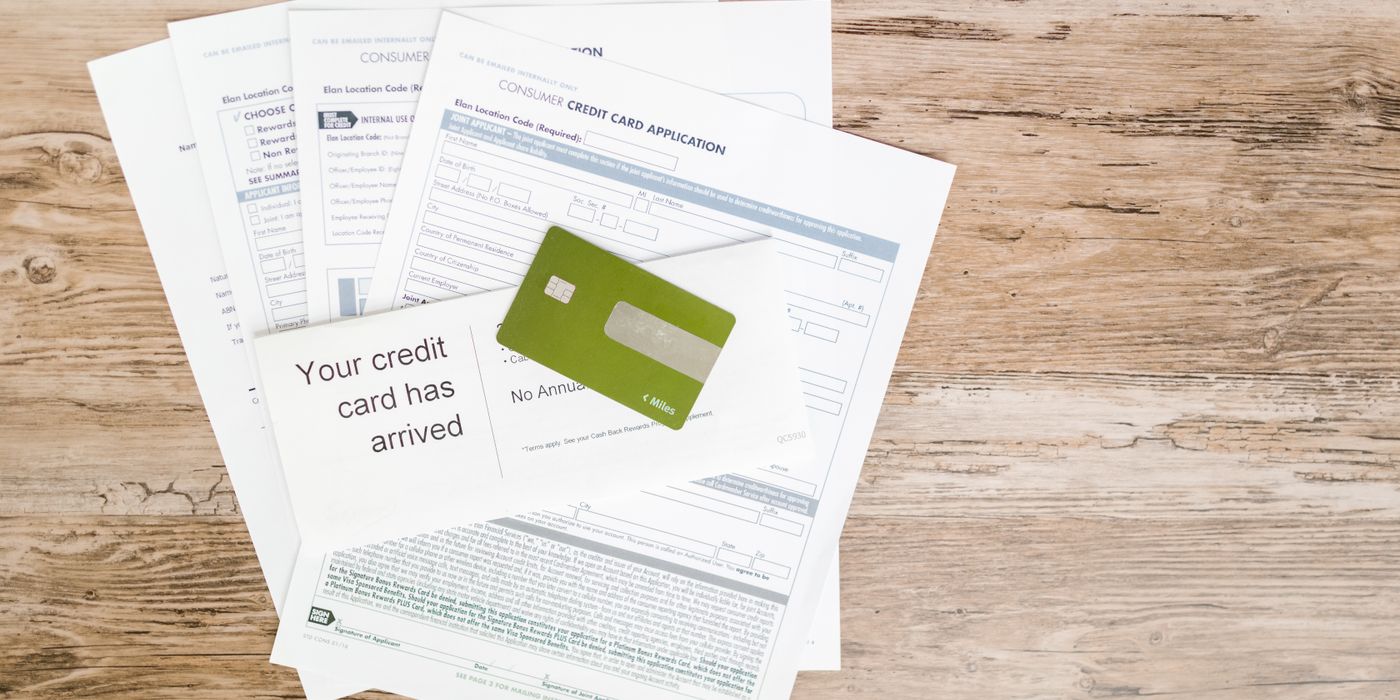 Credit card resting on travel documents before booking a hotel