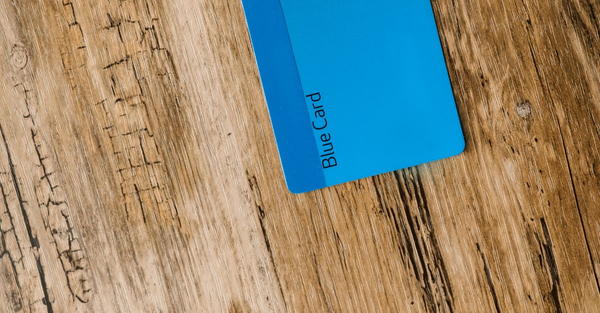 Blue Card on Wooden Surface · Free Stock Photo