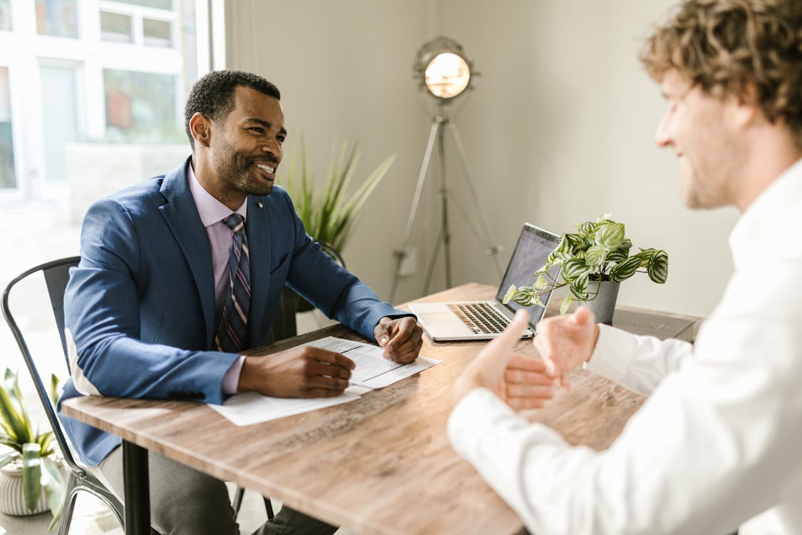 Free Men Sitting at Table Smiling Stock Photo