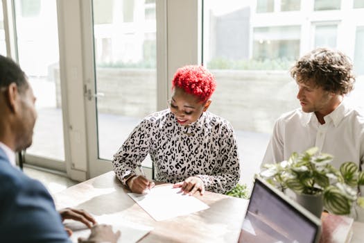Diverse professionals reviewing documents in a bright, modern office setting.