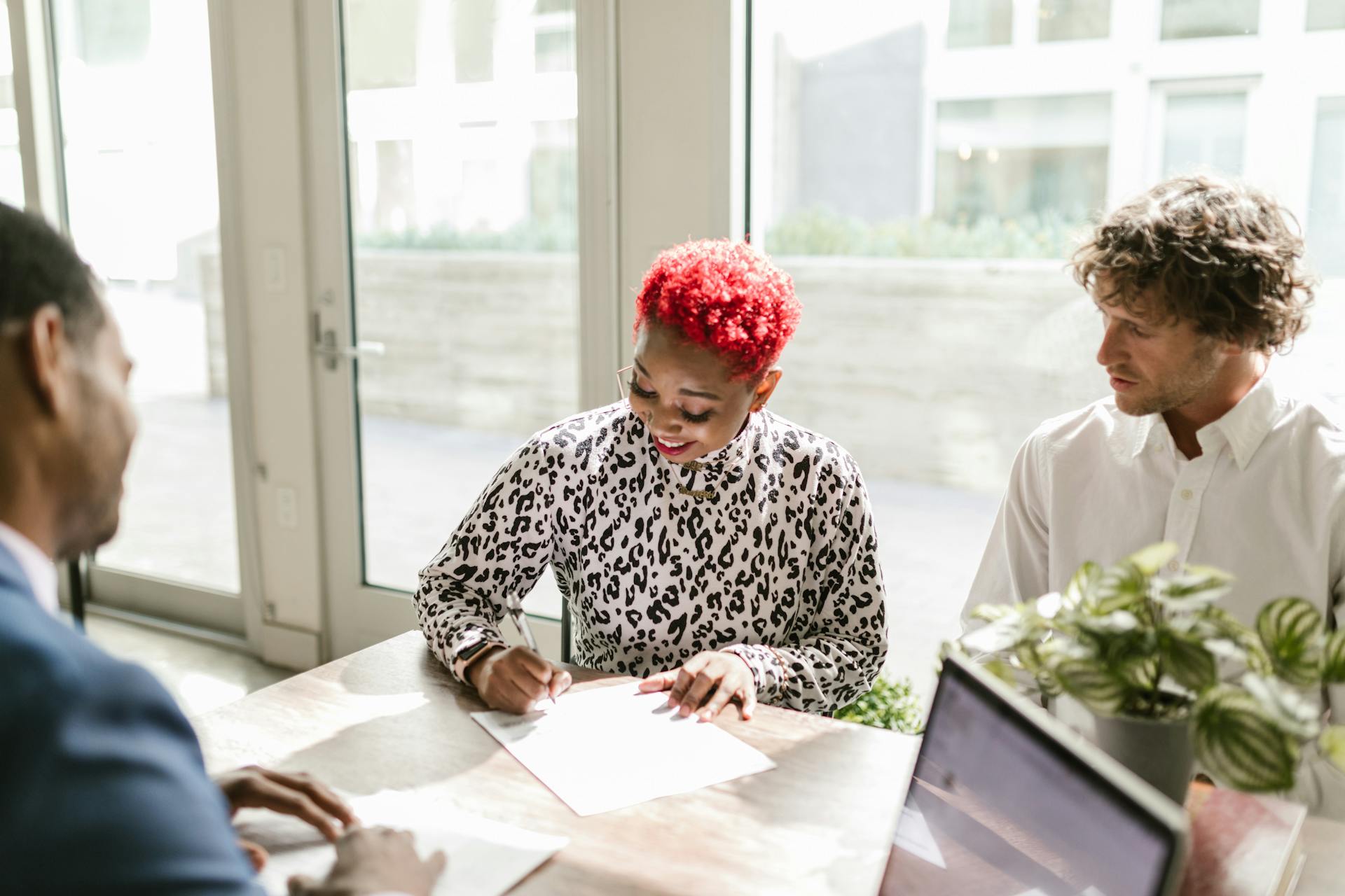 Diverse professionals reviewing documents in a bright, modern office setting.