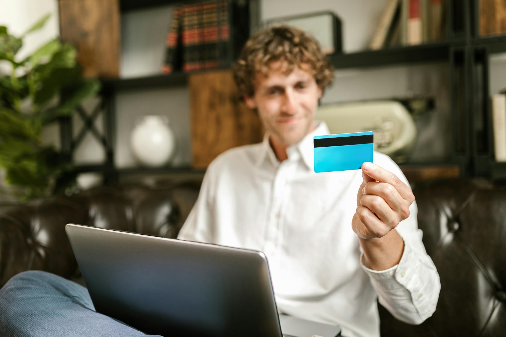 Man in White Long Sleeve Shirt Holding a Credit Card