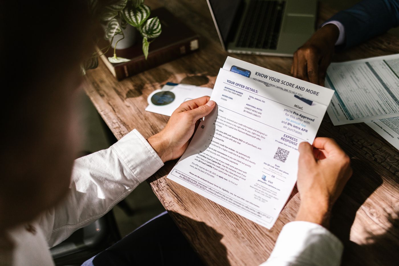 Person carefully reviewing financial documents before applying for a personal loan