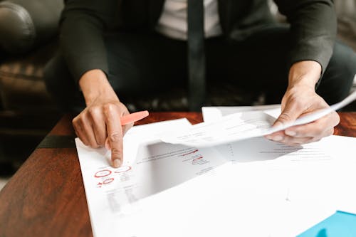 Close-up Photo of Person pointing on Documents 