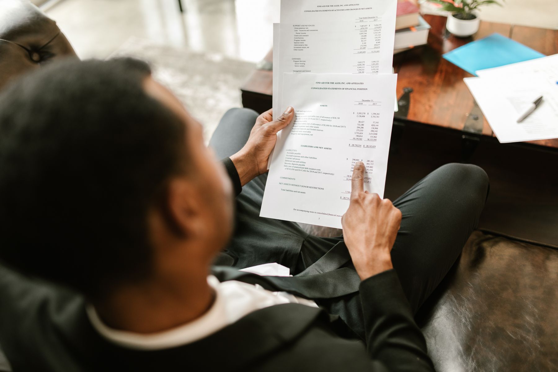 Colleagues pointing to details in printed business documents