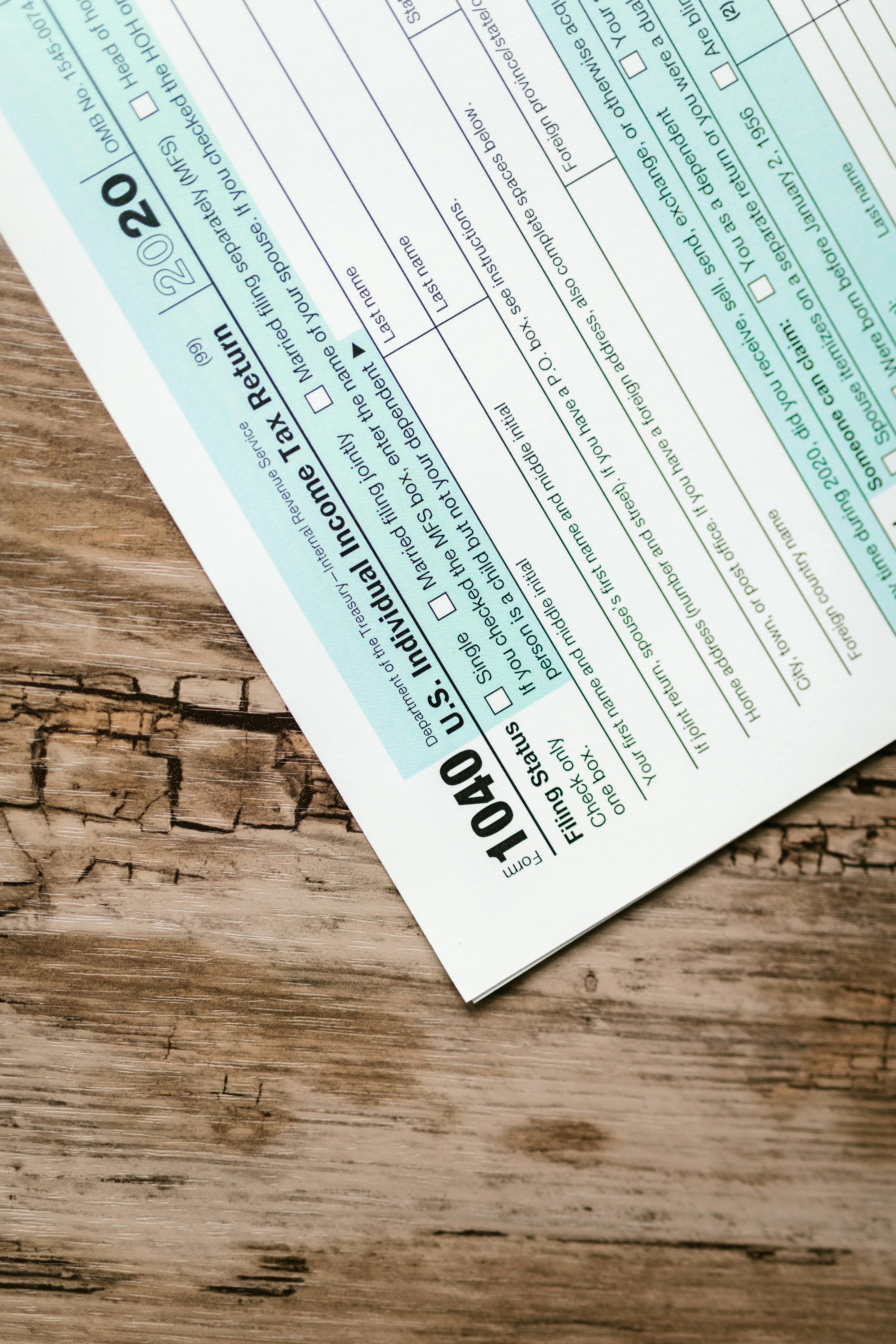A close-up view of a 1040 US Individual Income Tax Return form on a wooden surface.