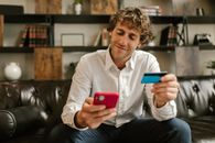 Man in White Dress Shirt Holding Red Iphone 5 C