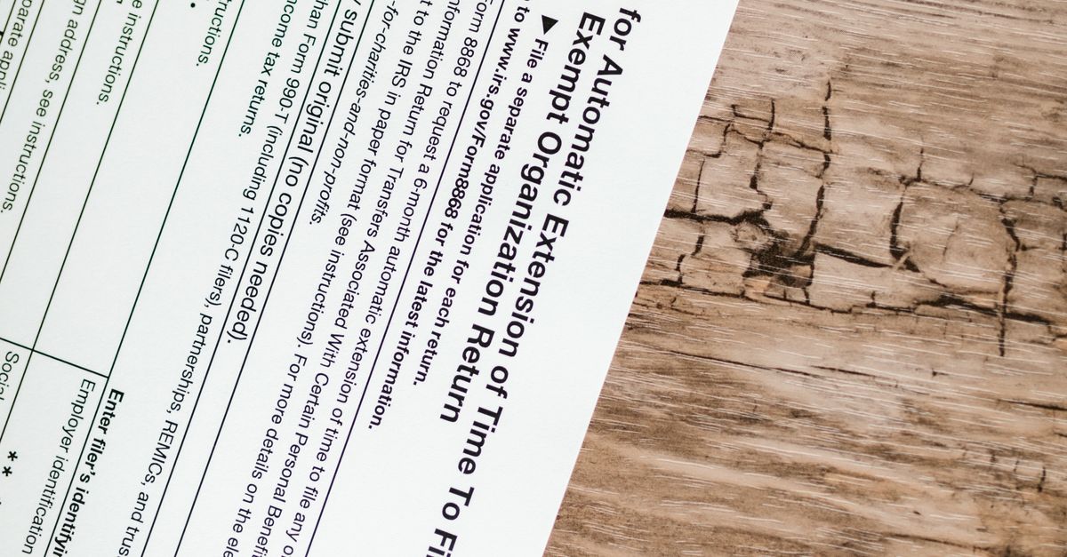 Photo by RDNE Stock project A tax form 8868 for filing extensions placed on a rustic wooden surface.