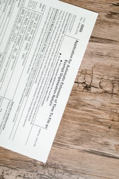 A tax form 8868 for filing extensions placed on a rustic wooden surface.