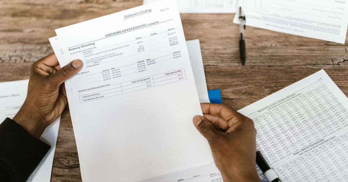 Balancing Income: A fitness professional reviewing financial documents in a small office