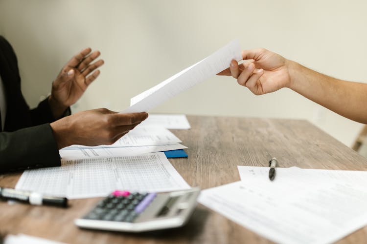 A Person Passing A Document