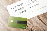 Green and Black Card on Brown Wooden Table
