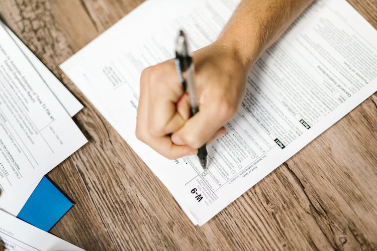 Close-Up Shot Of A Person Filling Out A Form