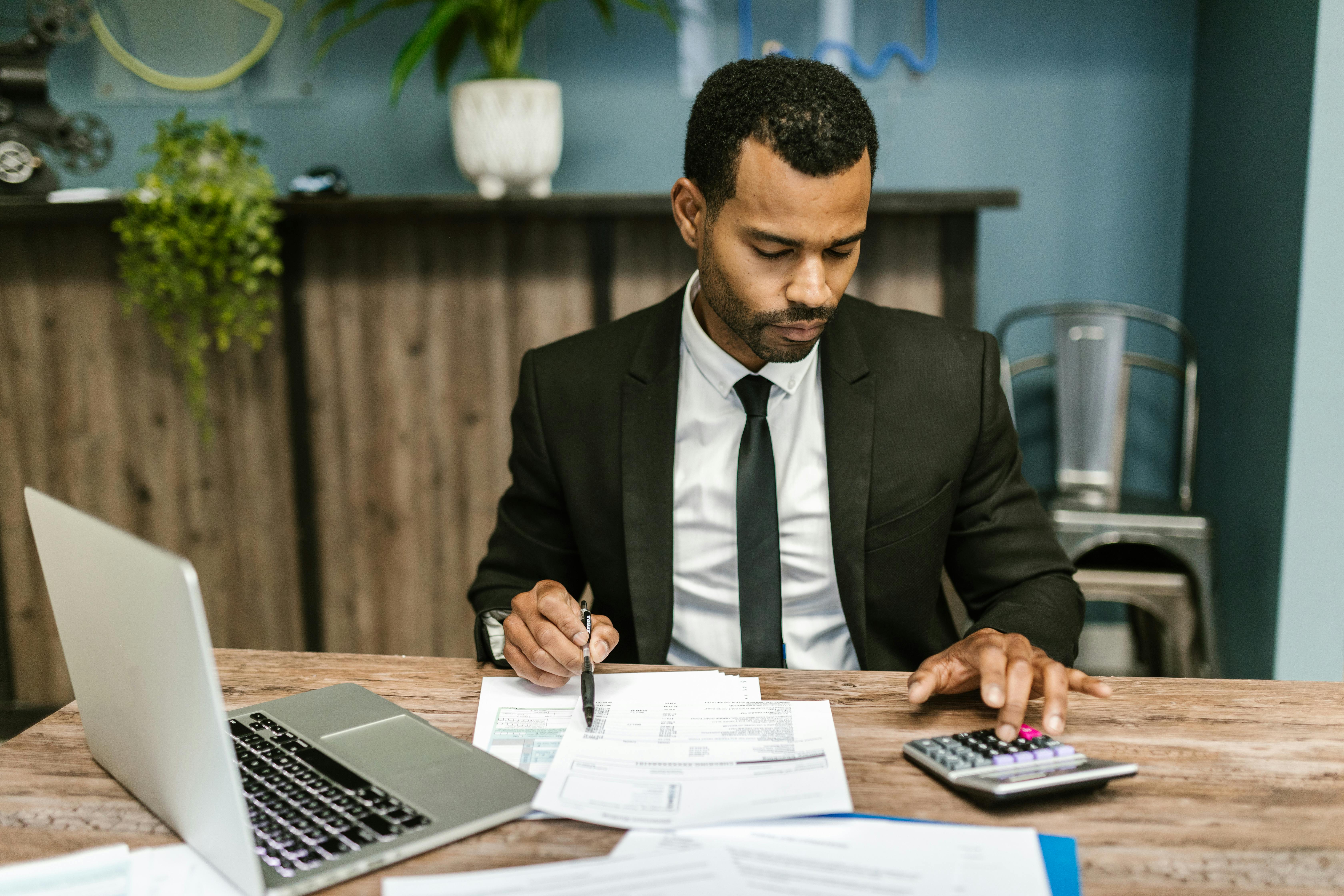 man in black suit working