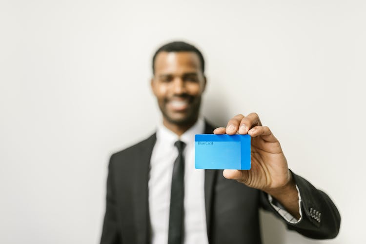 A Man Holding A Card