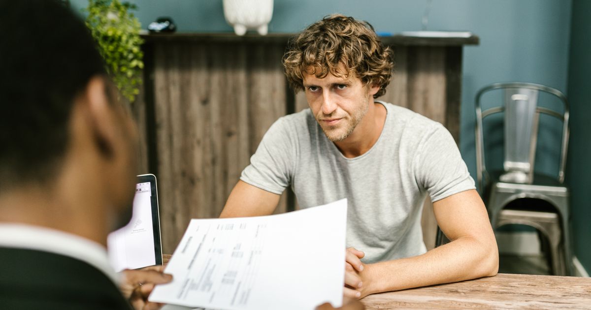 An athlete reviewing a contract with a sports agent in an office.