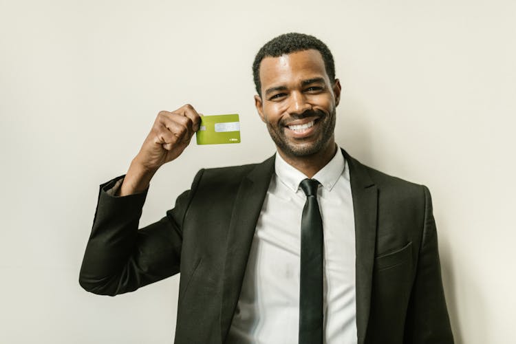 A Man Holding A Card