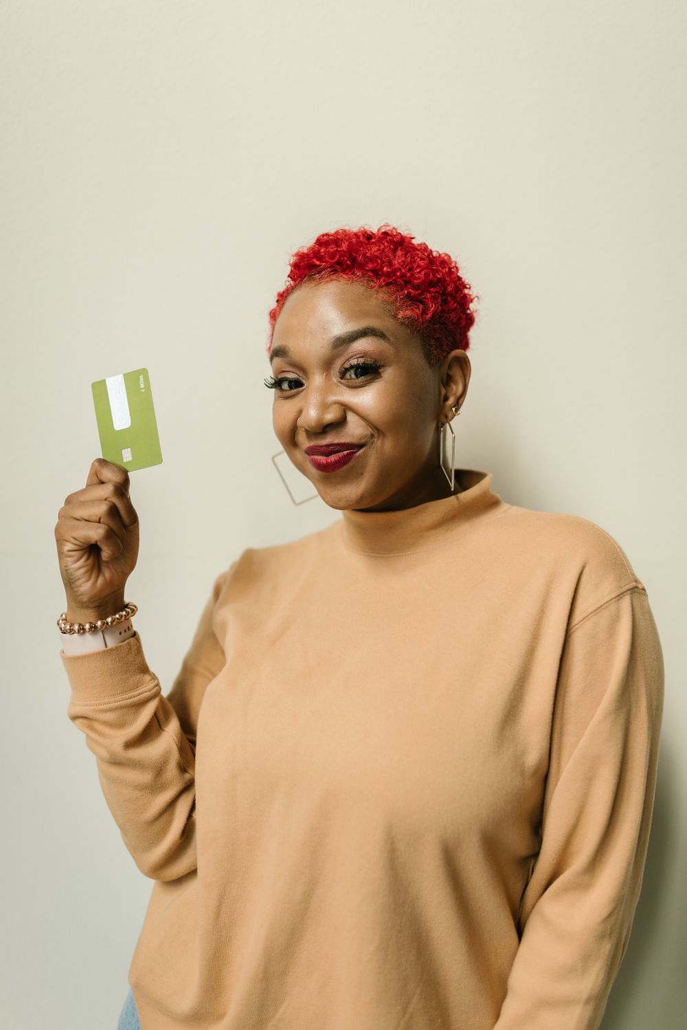 Woman smiling while holding her bank card