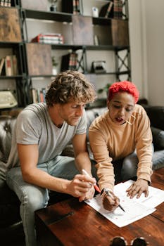 Two colleagues collaborating on documents in a stylish office setting.