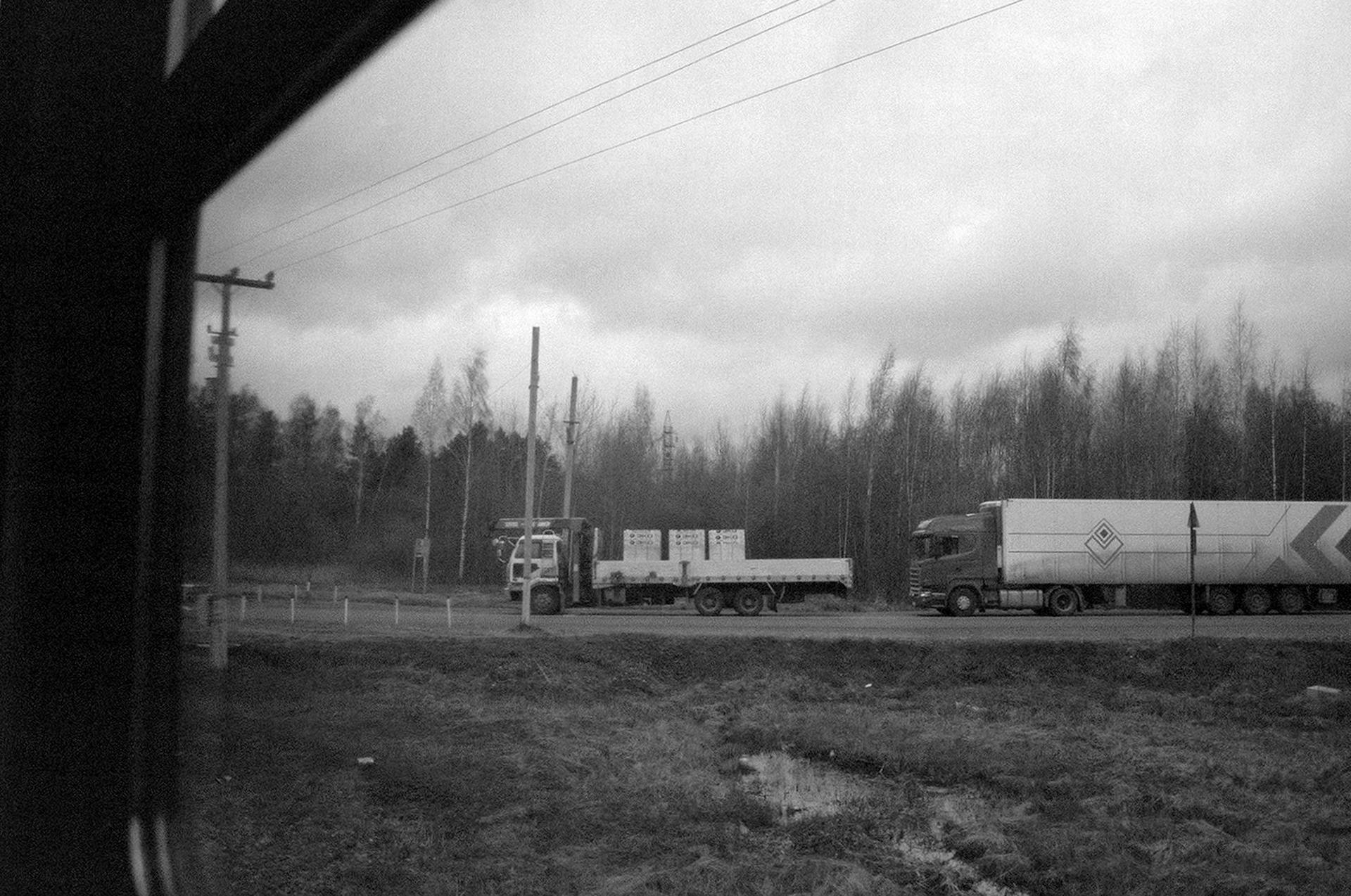 Trucks on Road near Forest