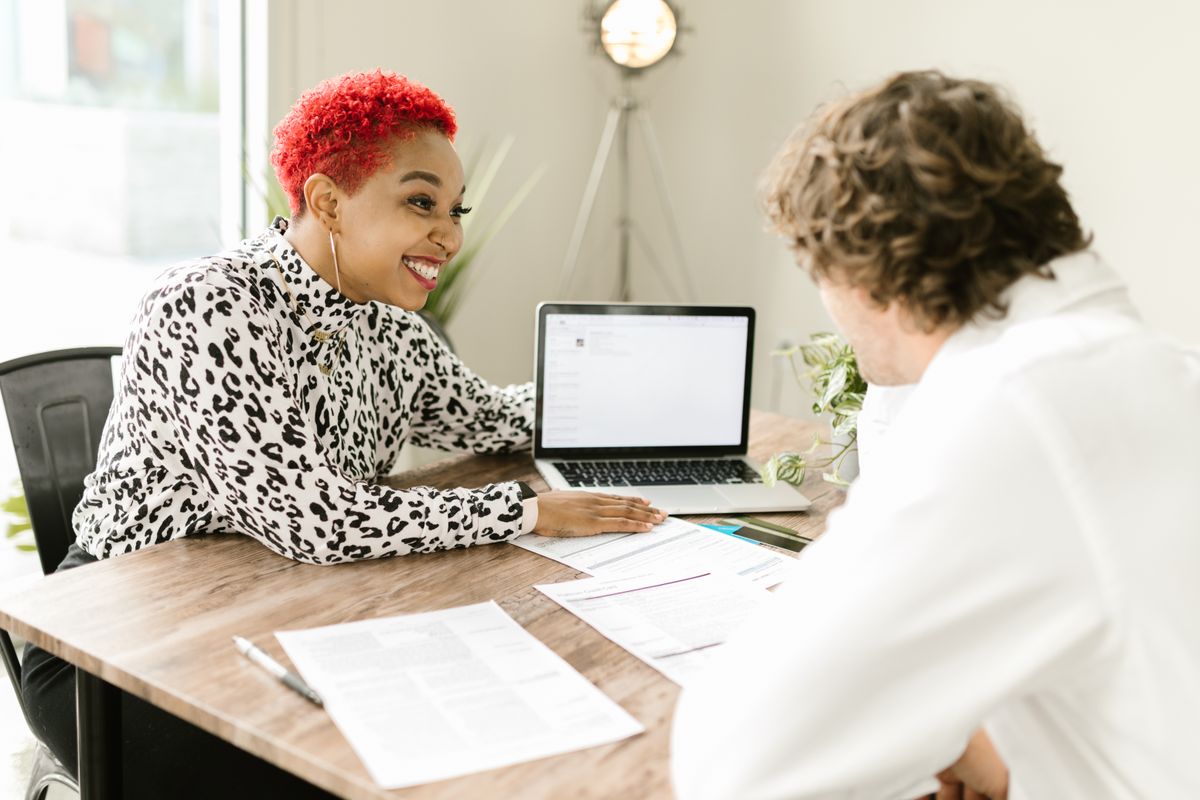 Accountant reviewing corporation tax documents with a business owner