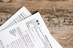 Detailed shot of tax forms on a wooden surface, ideal for concept themes like finance and documentation.