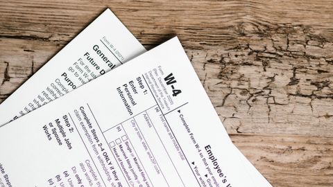Detailed shot of tax forms on a wooden surface, ideal for concept themes like finance and documentation.