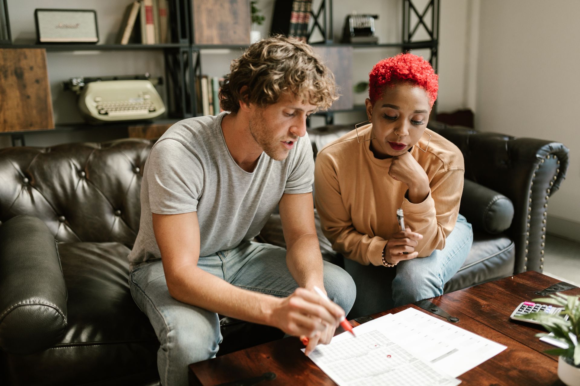 A Couple Looking at Documents on a Coffee Table