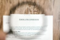 Selective Focus Photo of Terms and Conditions Written on a Paper