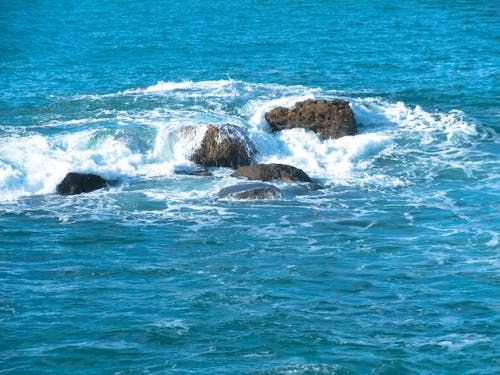 Brown Rock Formations on Sea