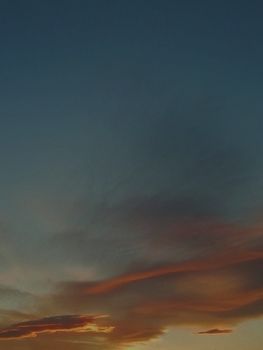 A serene twilight sky featuring vibrant, colorful clouds at sunset. Perfect for background use.