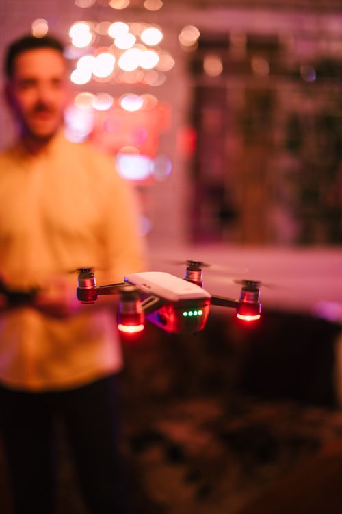 Free Vibrant indoor scene featuring a drone with red lights and blurred bokeh background. Stock Photo