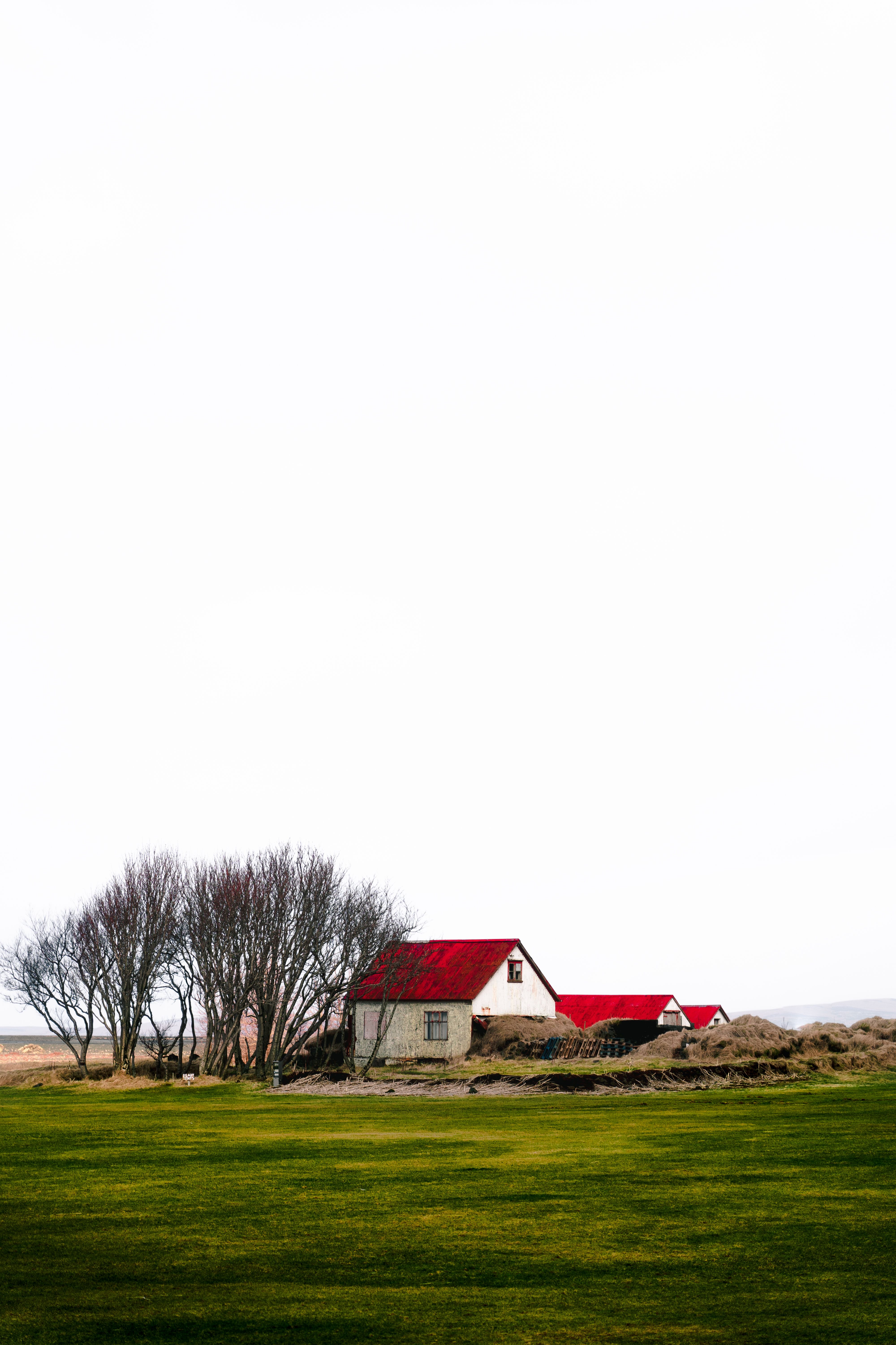 Red and White House Near Green Grass Field Under White Sky · Free Stock ...
